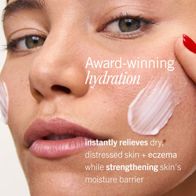 First Aid Beauty cream on palm being spread for quick non-greasy skin relief