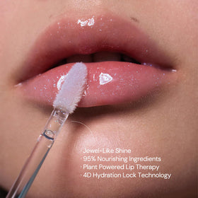 Flower Knows gloss layered over red lipstick amplifying sparkle
