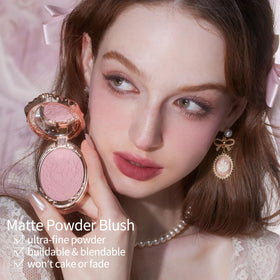 Flower Knows open compact top-down showing petal-pink powder and embossed pattern