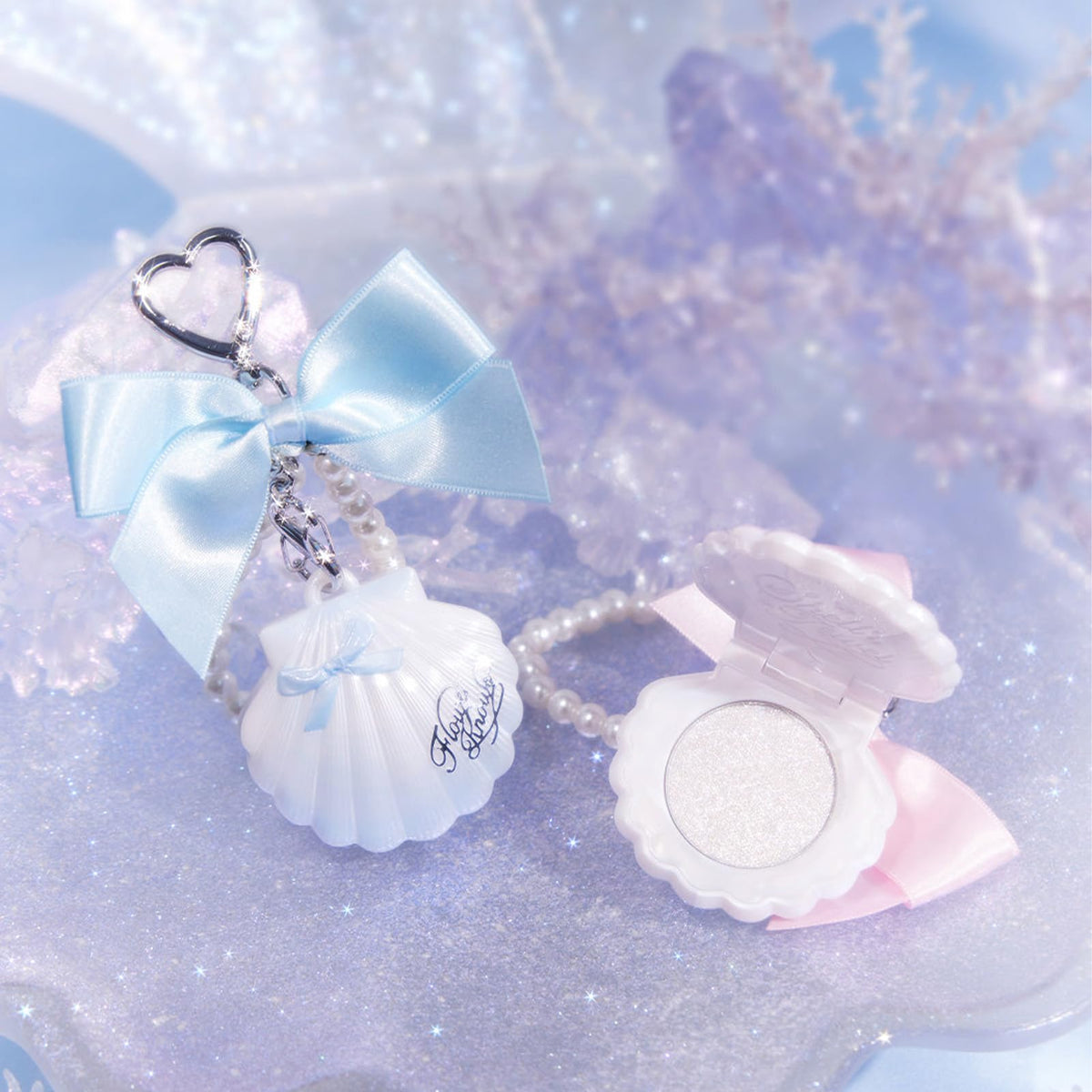 Flower Knows flatlay with shell and accessories illustrating gift-ready presentation