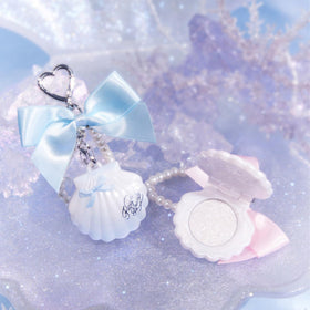 Flower Knows flatlay with shell and accessories illustrating gift-ready presentation