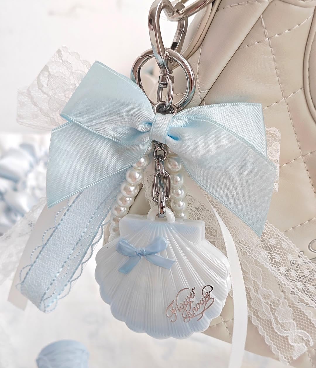Flower Knows shell held in hand showing compact size for purse convenience