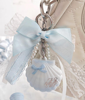 Flower Knows shell held in hand showing compact size for purse convenience