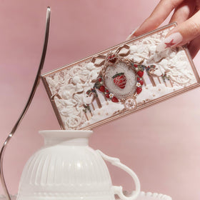 Flower Knows packaging artwork close-up with ornate strawberry design