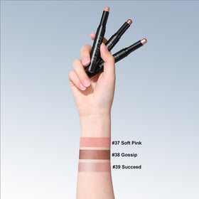 FOCALLURE sticks in hand to show scale and travel-friendly portability benefit