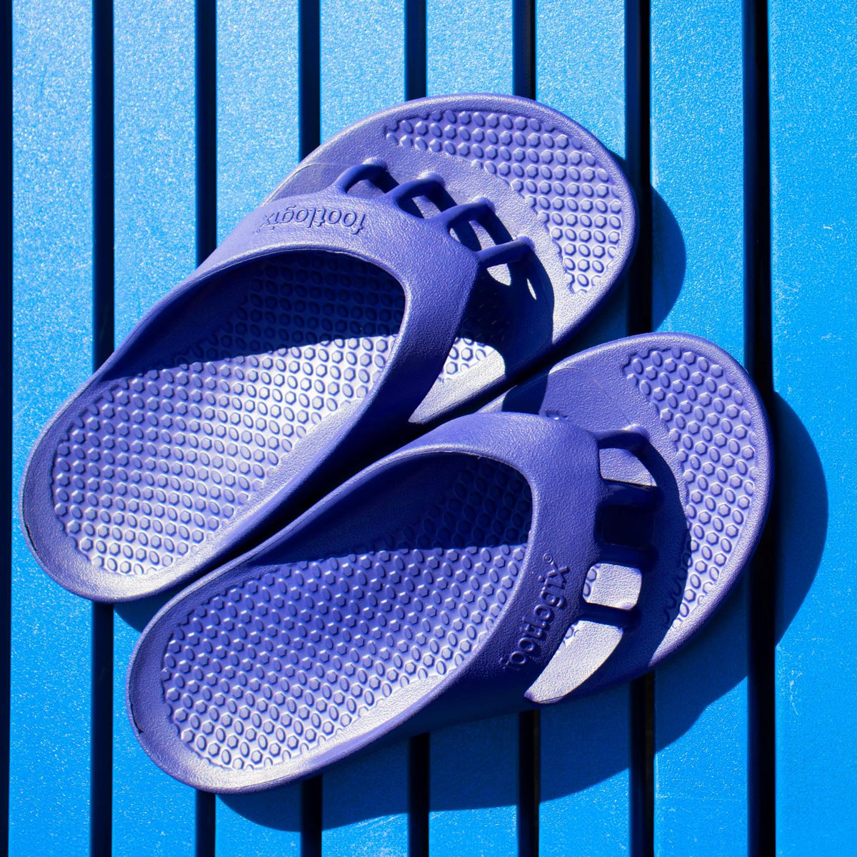 FOOTLOGIX sandal beside ruler size comparison for accurate fitting guidance