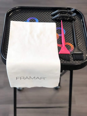FRAMAR towel in hands demonstrating quick absorbency and comfort