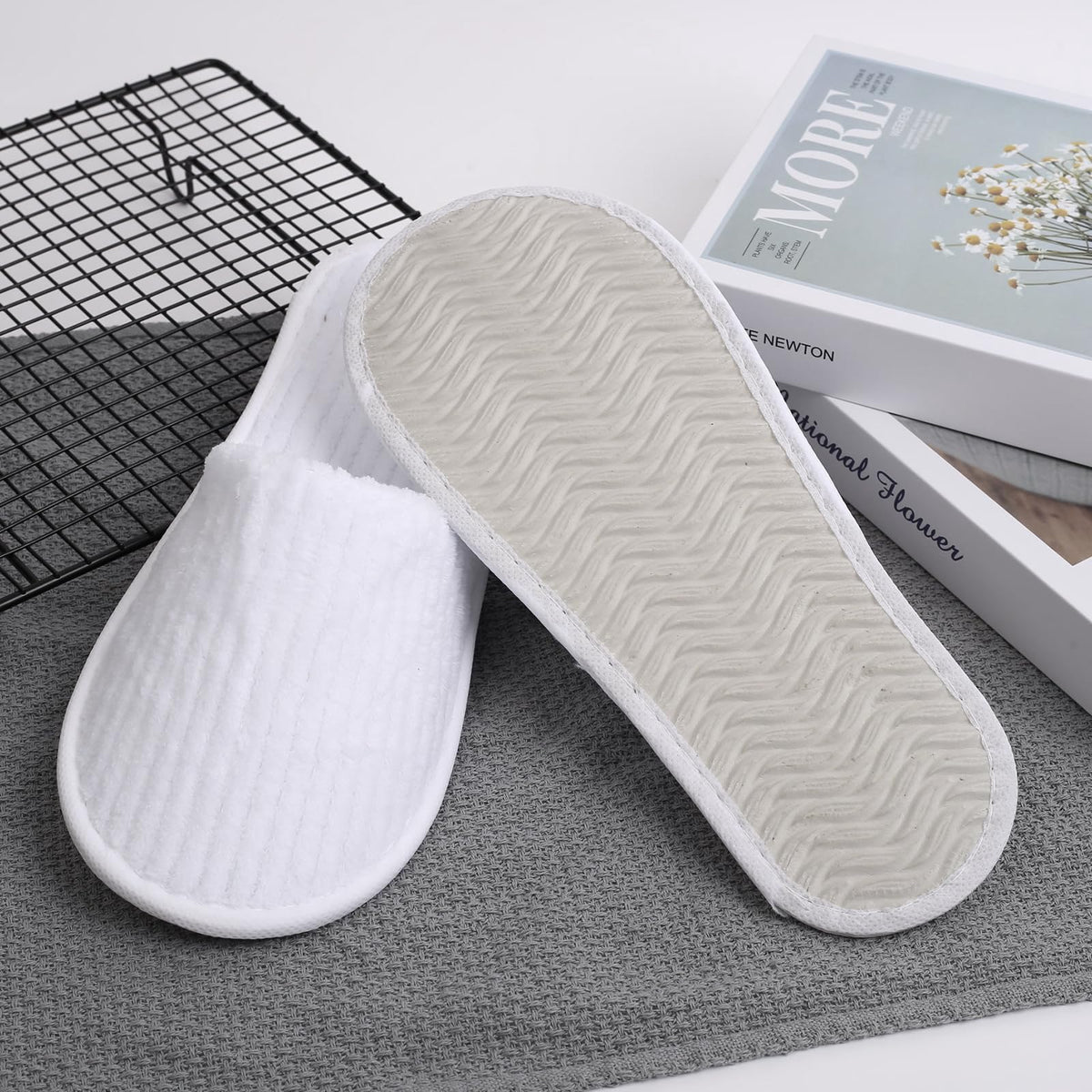 Frcctre slippers in a hotel room setting conveying professional guest presentation