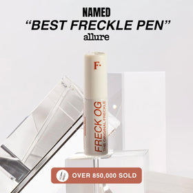 Freck Beauty pen beside makeup bag highlighting on-the-go touch-up ease