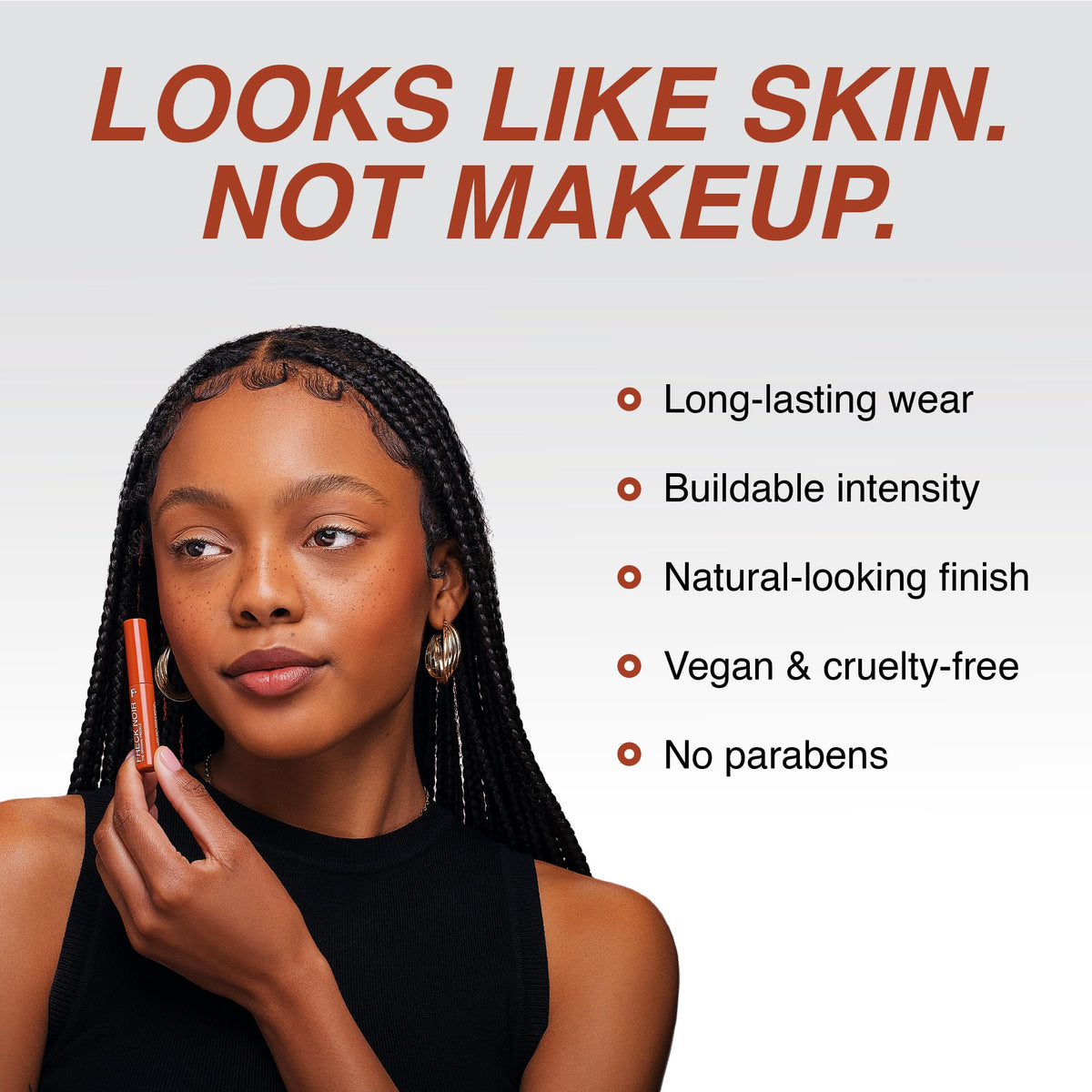 Freck Beauty NOIR application in hand showing targeted dotting and blending benefit