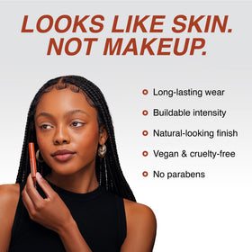 Freck Beauty NOIR application in hand showing targeted dotting and blending benefit