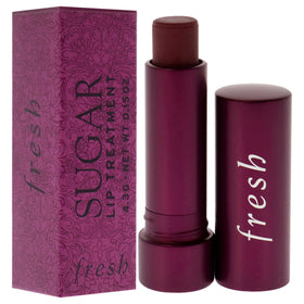 Fresh Sugar Lip Treatment berry held in hand to show compact travel size benefit