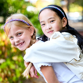 FROG SAC headband worn by child outdoors showing secure hold during play