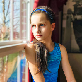 FROG SAC headband worn during gymnastics showing secure hold