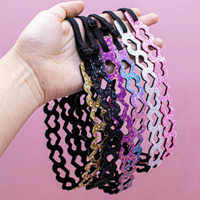 FROG SAC headband next to ruler showing adjustable size range