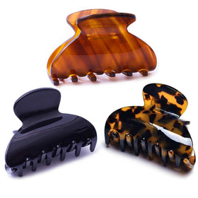 Fsmiling front view of three tortoise black brown clips shows polished finish and style