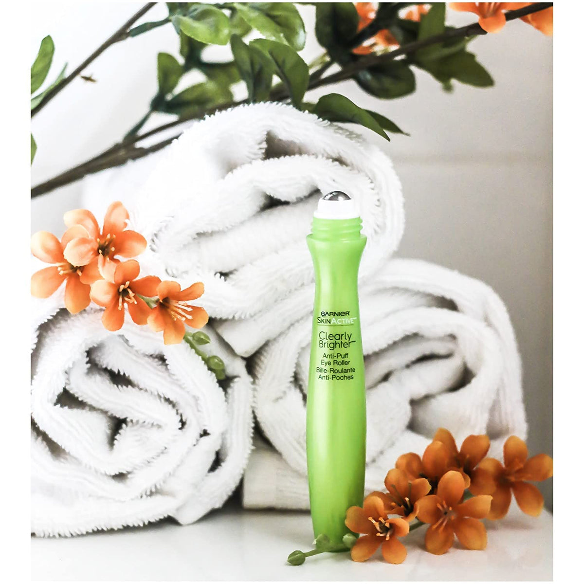 Garnier applying roller under eye for instant de‑puffing refresh