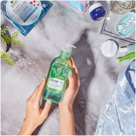 Garnier bottle with green tea leaves conveying natural ingredient benefit