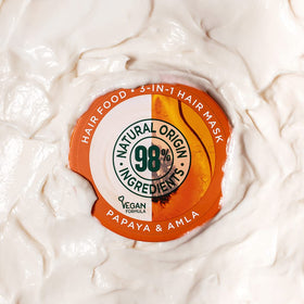 Garnier jar in hand illustrating easy scoop and creamy feel