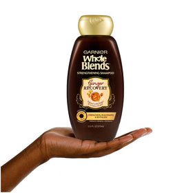 Garnier bottle beside ginger root and honey jar highlighting ingredients