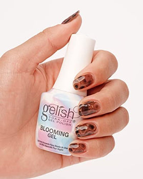 Nail technician using Gelish Blooming Gel in salon to create watercolor nail art efficiently