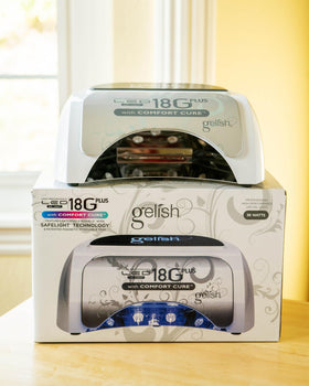 Gelish lamp curing a hand to demonstrate steady professional performance