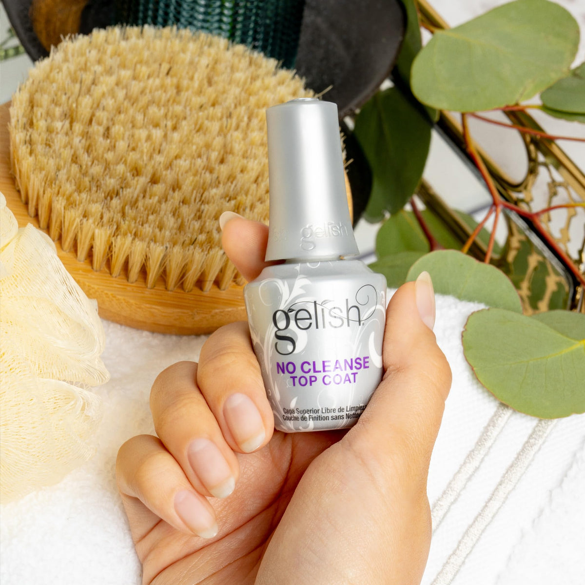 Gelish 15mL bottle beside a ruler showing compact size and travel-friendly benefit