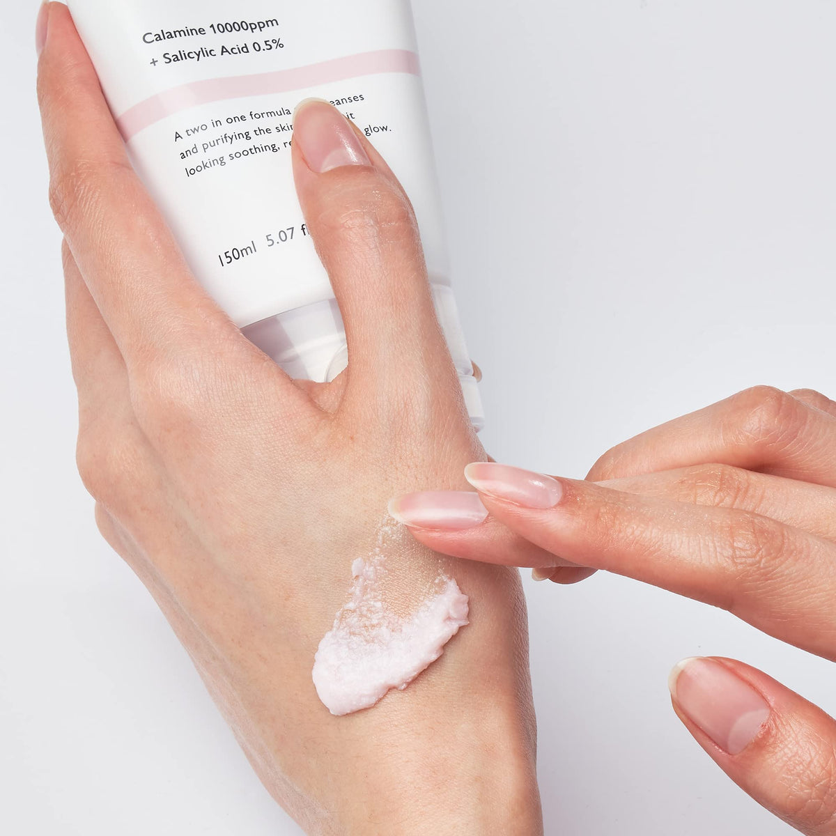 Genabelle held in hand for scale to show travel-friendly 5.07 fl oz size