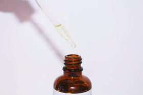 Generic bakuchi oil scale comparison beside a ruler showing 100ml size and value