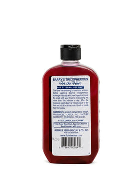 Person applying Generic Barrys Tricopherous to hair while styling, demonstrating added manageability