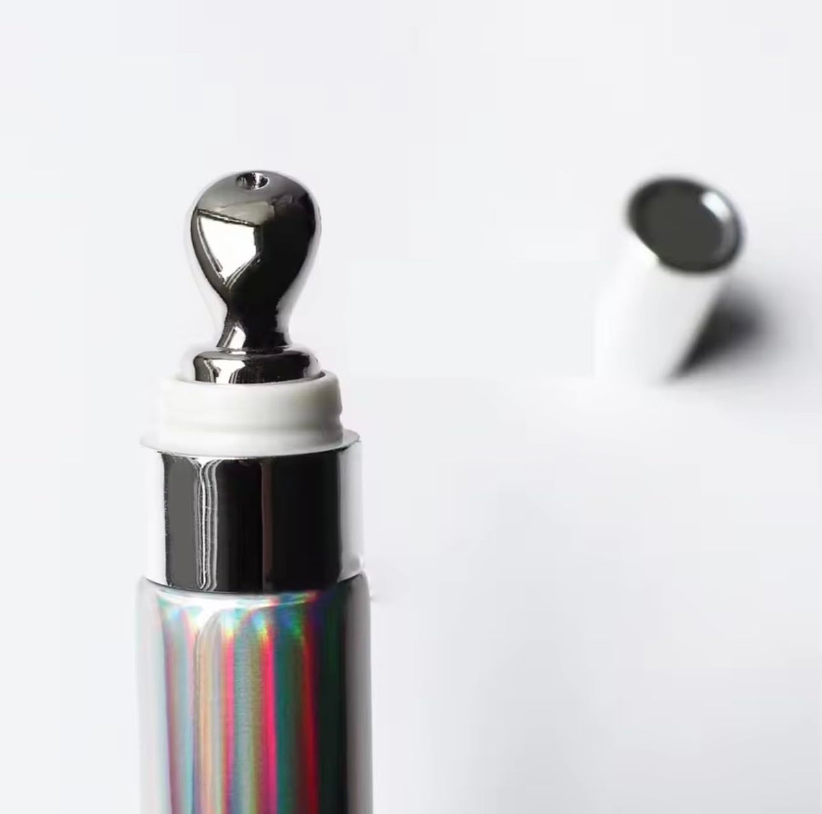 Generic applicator wand angled above lips demonstrating easy precise application benefit