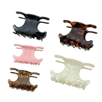 Generic front view of five acetate butterfly clips showing color variety and polished finish for stylish hold