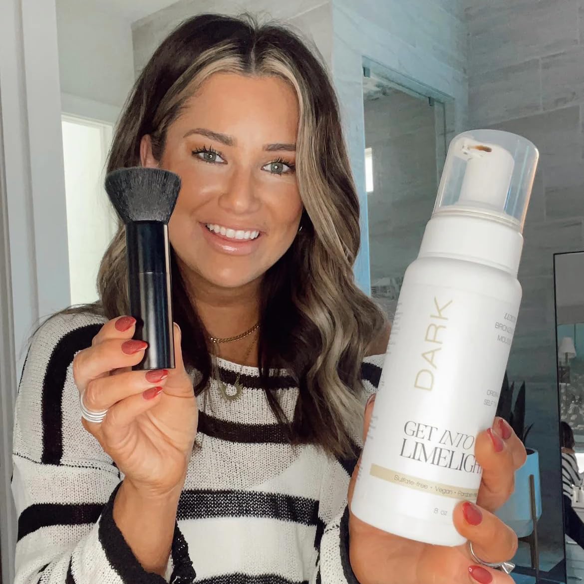 Get Into The Limelight 8 oz bottle beside hand for scale, lasting multiple applications benefit
