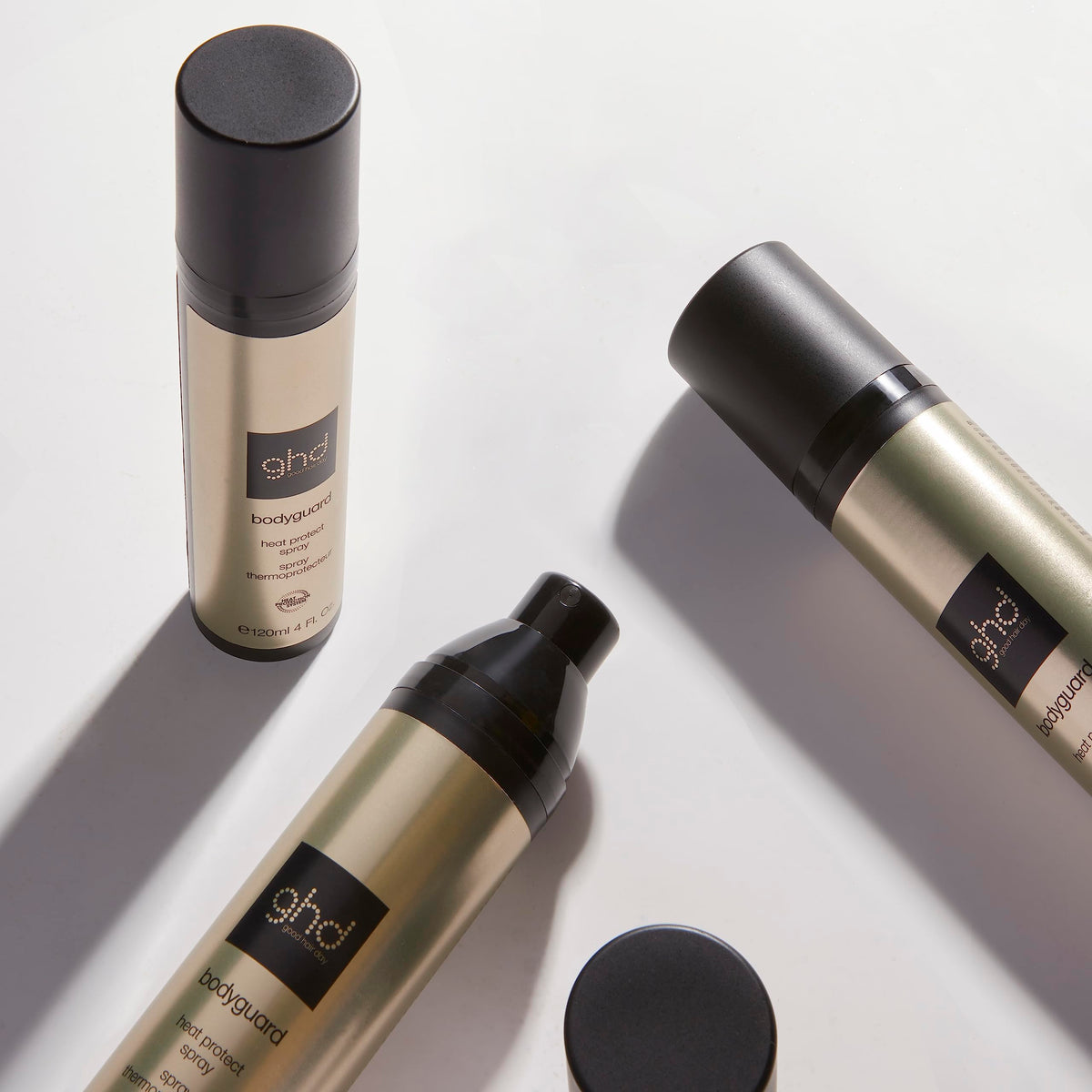 ghd bottle next to a coin showing 4 fl oz size benefit