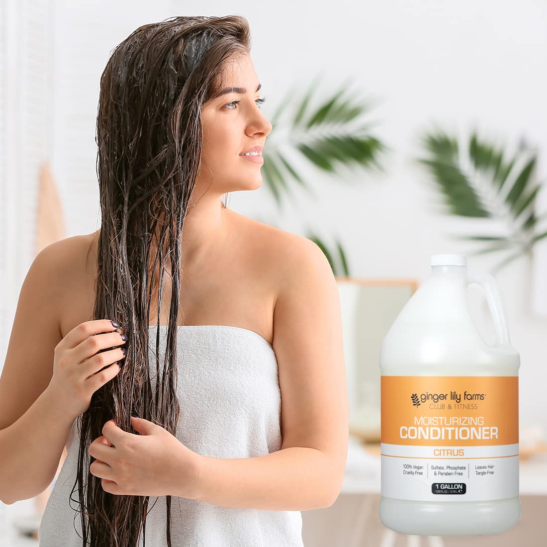 Model rinsing hair with Ginger Lily Farms conditioner showing softer, more manageable hair
