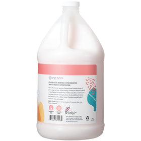 Ginger Lily Farms pouring conditioner into dispenser for quick refill and savings