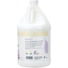 Ginger Lily Farms pouring conditioner into dispenser for economical refills