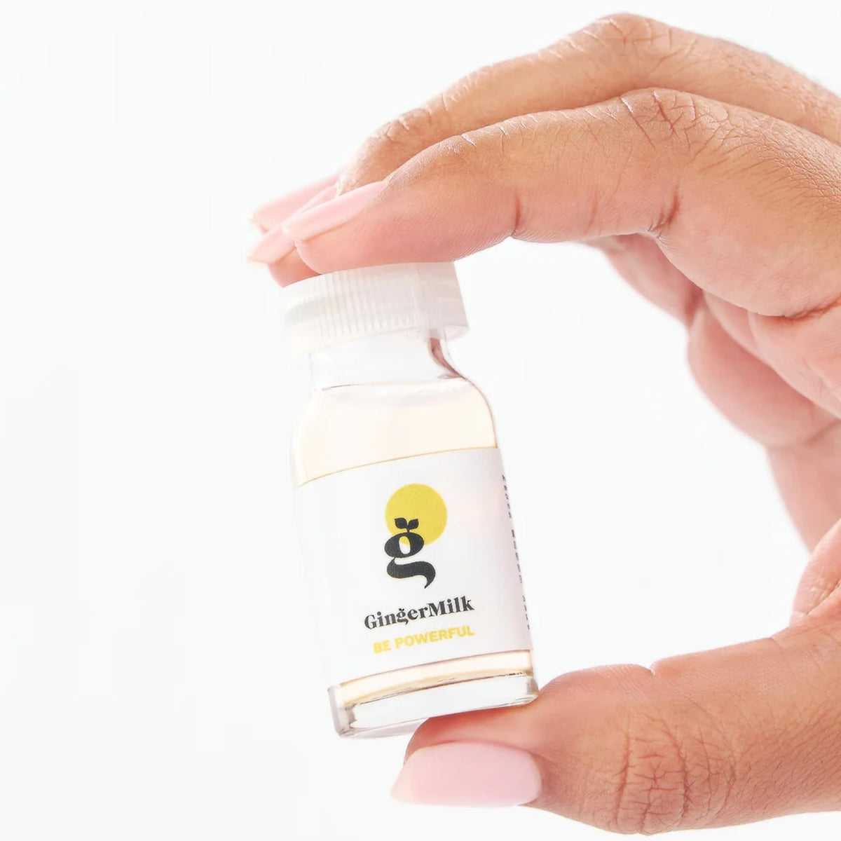Ginger Milk ampoule next to a coin for size comparison and portability
