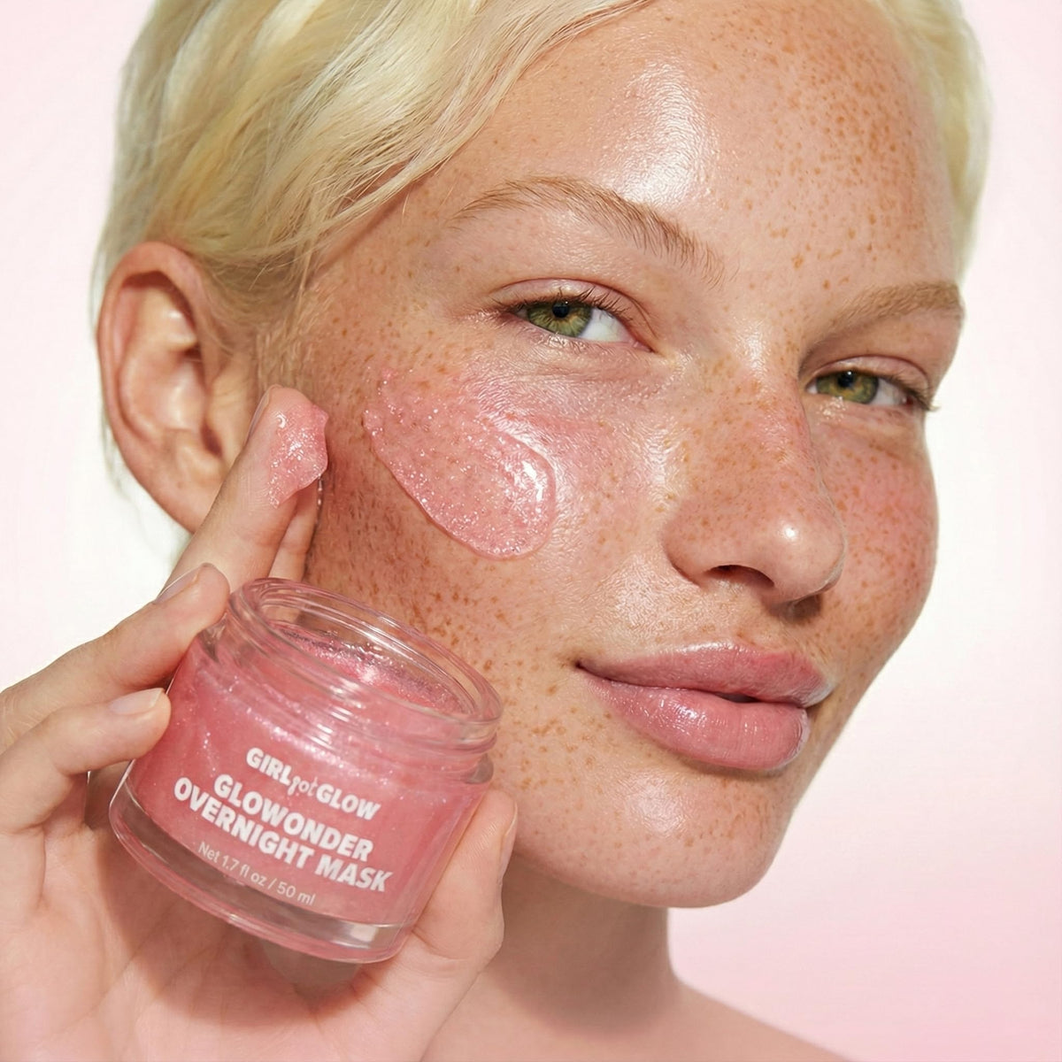 Girl Got Glow jar held between hands to show 50 mL size and travel-friendly benefit