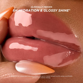 Gisou applicator close-up displaying smooth lip oil texture and precise application