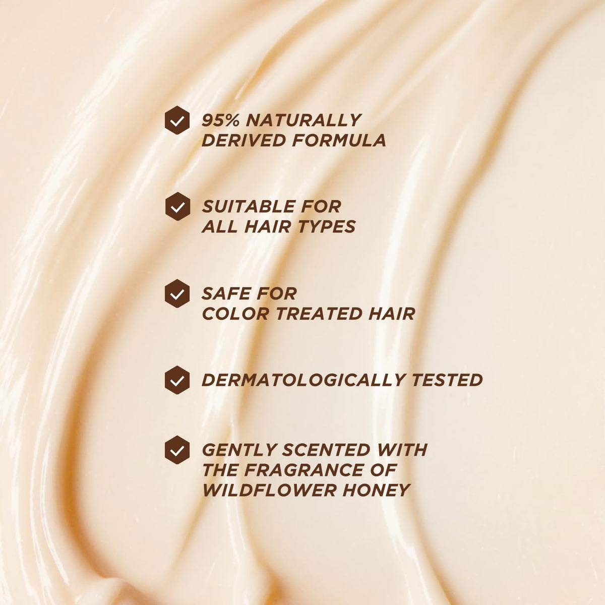 Gisou conditioner swatch on hands illustrating silky texture and detangling slip for less breakage