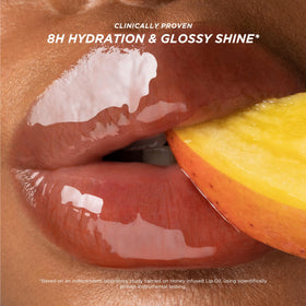 Gisou lip oil on model lips delivering juicy mango color and comfortable hydration