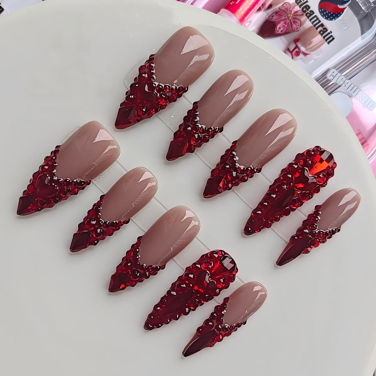 Gleamrain front packaging showing nude base and red rhinestone accents, elegant presentation