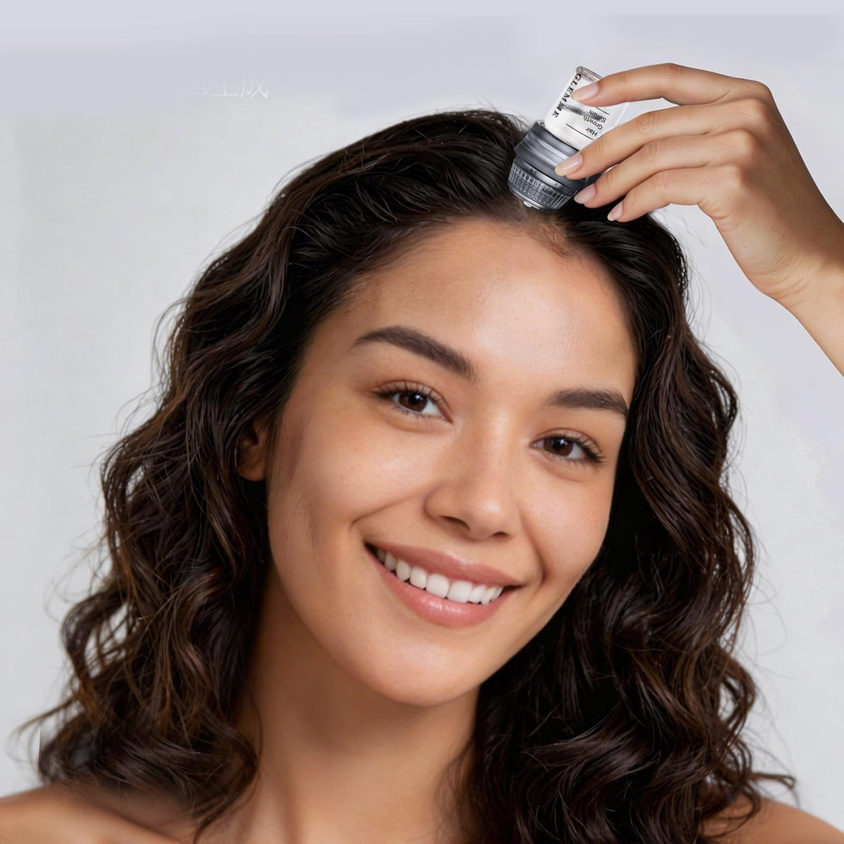 Glemme applying serum to scalp demonstrating controlled, neat application