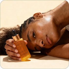 Glo Melanin in hand to show bottle size and travel-friendly convenience