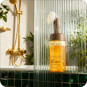 Glo Melanin product beside rose water and aloe illustrating soothing hydration