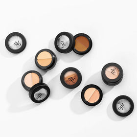 Glo Skin Beauty model applying concealer under eye to show coverage and brightening benefit