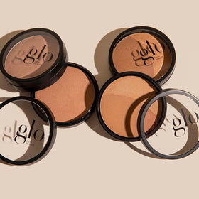 Model applying Glo Skin Beauty bronzer to cheekbone for natural contouring benefit