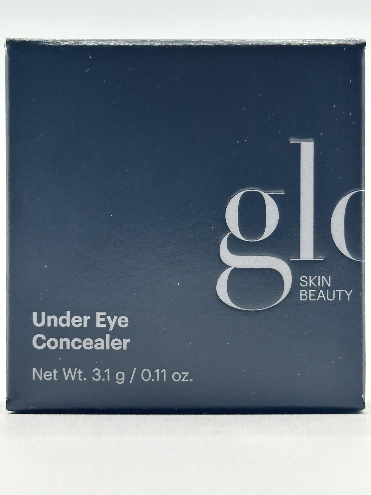Glo Skin Beauty concealer held in hand showing compact size and travel-friendly benefit