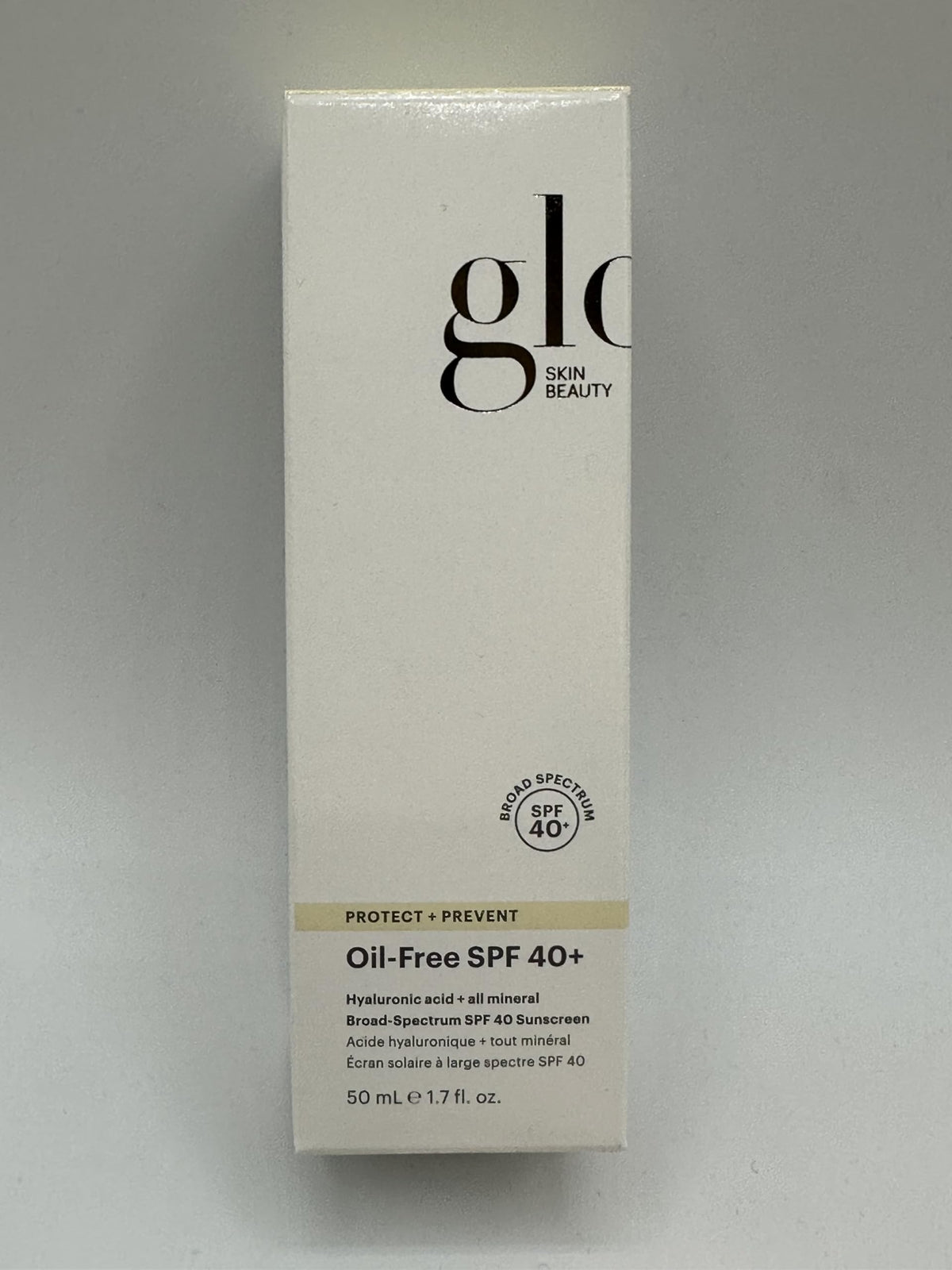 Glo Skin Beauty bottle next to ruler showing compact 1.7 fl oz travel size